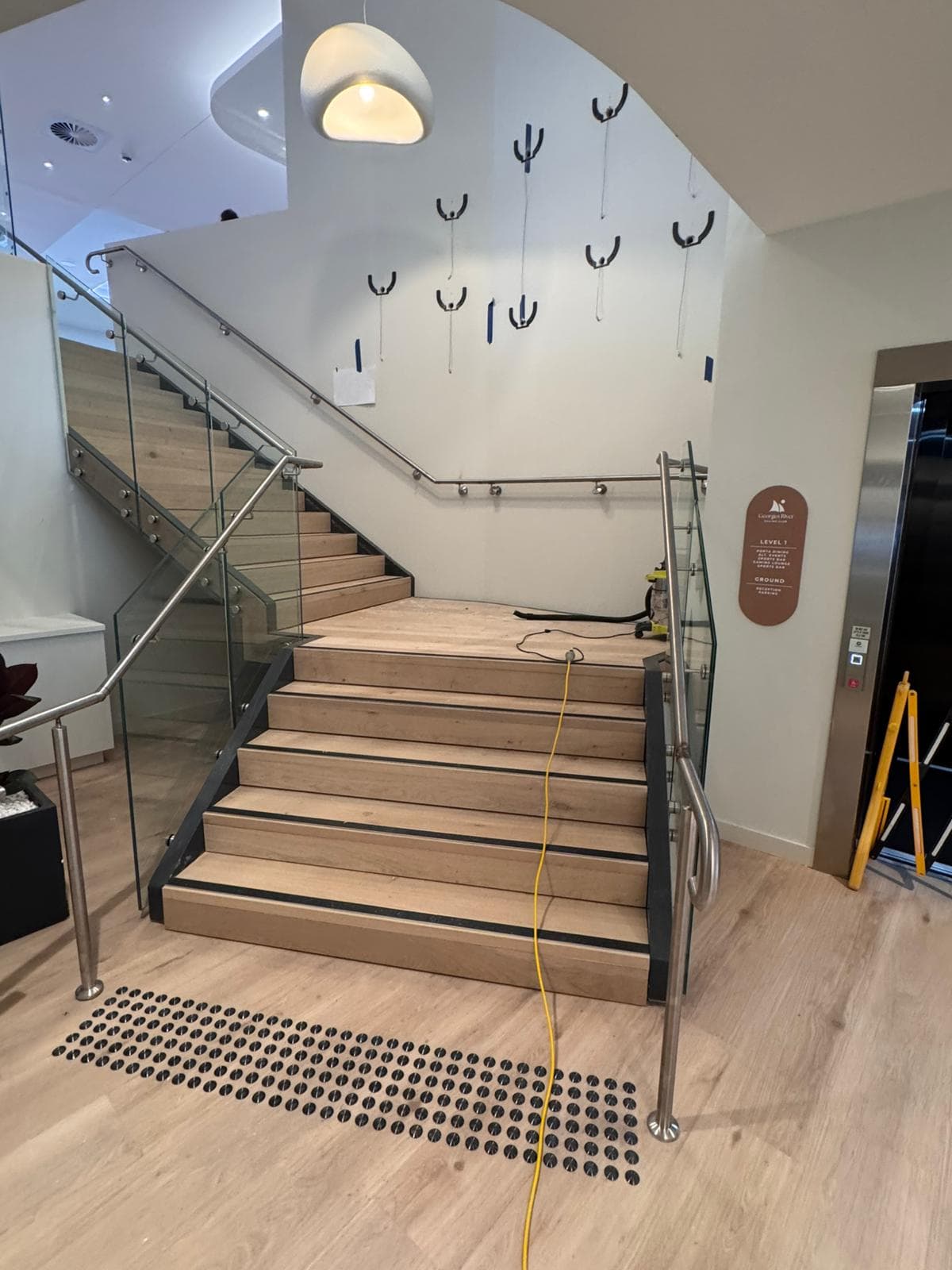 Stainless handrails and frameless glass balustrade on a timber stair, Sans Souci