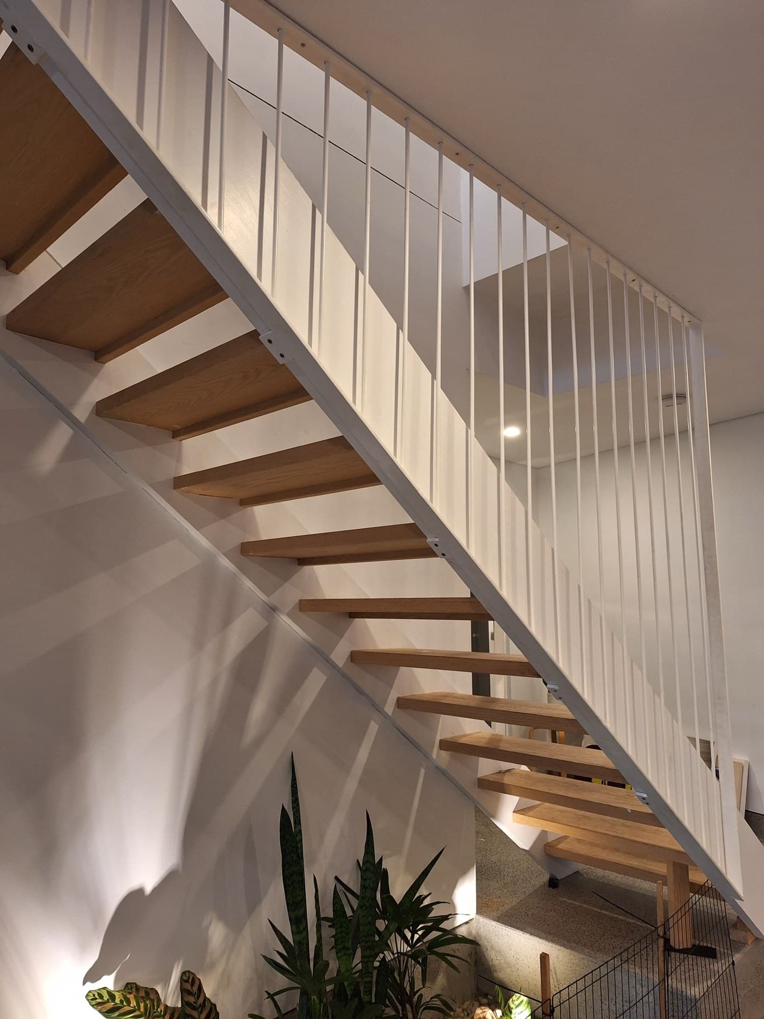 White steel stair stringer with vertical rod balustrade, timber treads, Newport