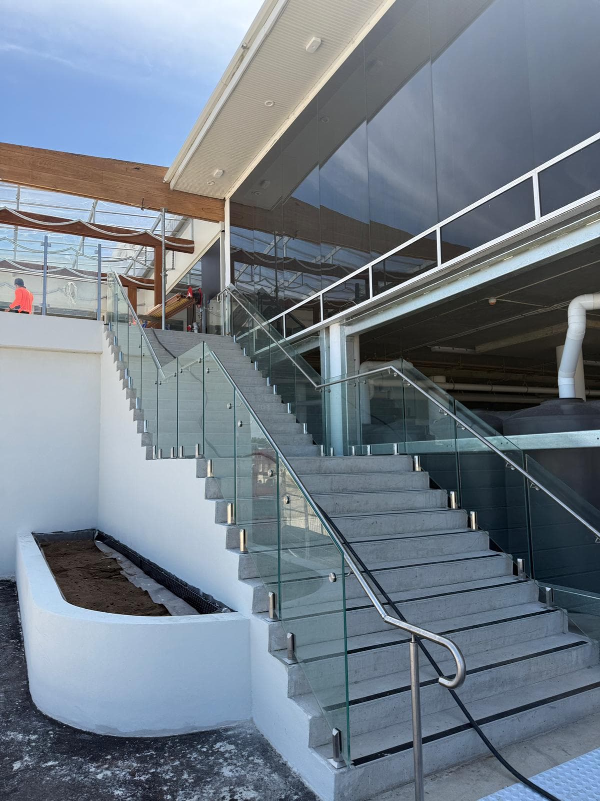 Stainless handrail and glass balustrade on an external concrete stair, Sans Souci
