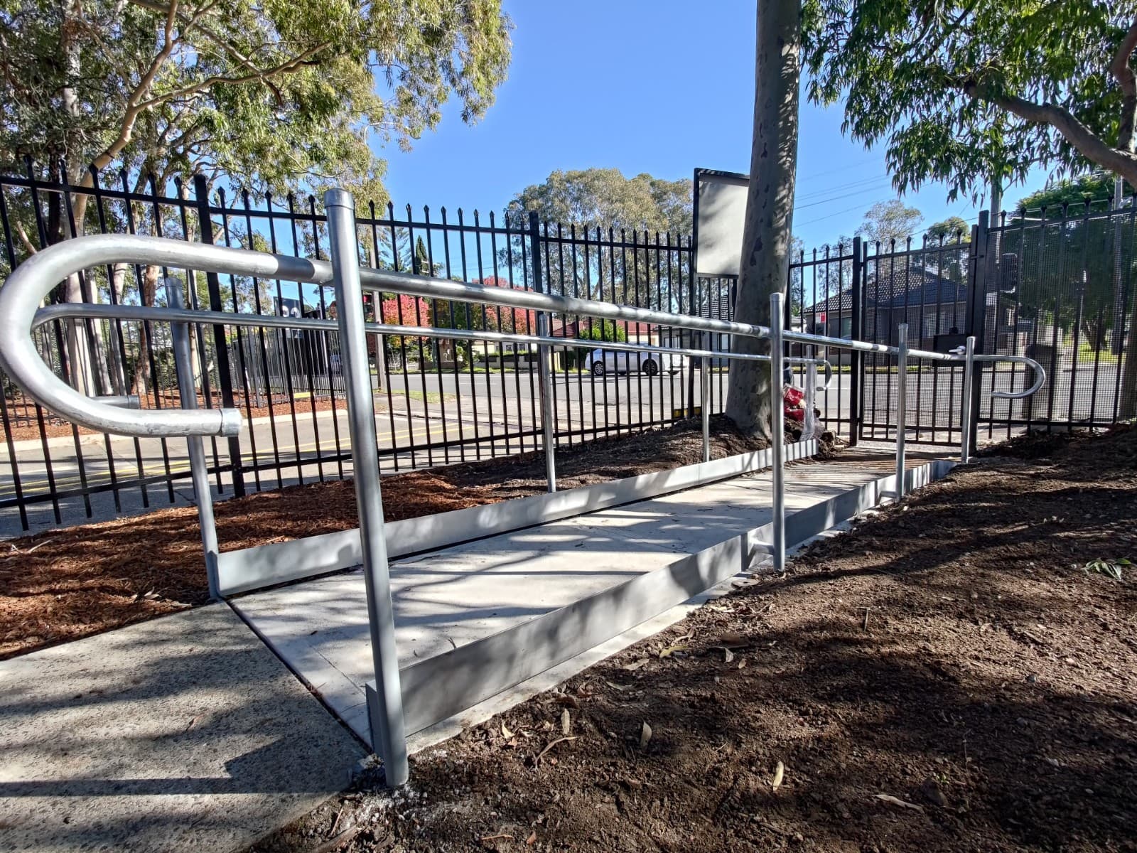 Galvanised CHS handrails and kerb rail on an access ramp